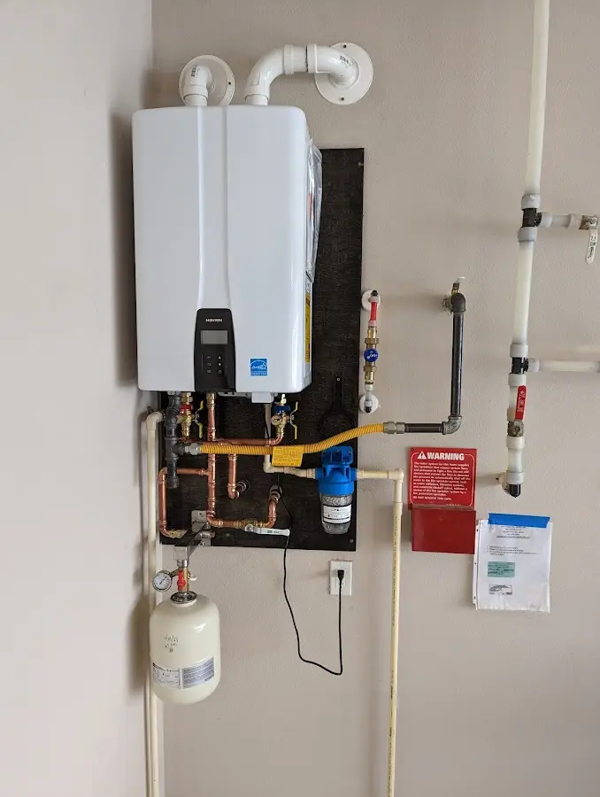 Professional plumber installing copper piping in a Hudsonville home